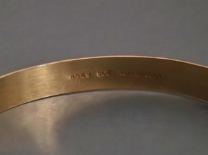 Helpful jewellers stamping "rolled gold" on the bangle rather than confusing us with mysterious fractions and letters.