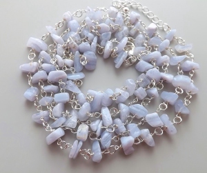 Image shows chip nugget blue lace agate beads, very pale blue in colour with subtle white striped banding on them,